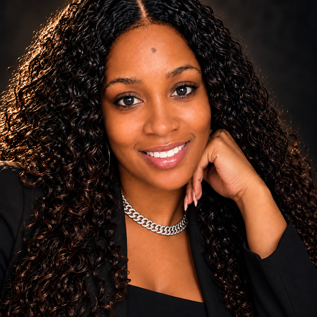 Sonya M. Stamps smiling, wearing a black jacket and silver necklace